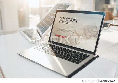 Laptop screen, solar panel or business strategy in empty office building in a startup company workplace. Financial growth, computer desk or pc online on website information or ui data on internet 130603482