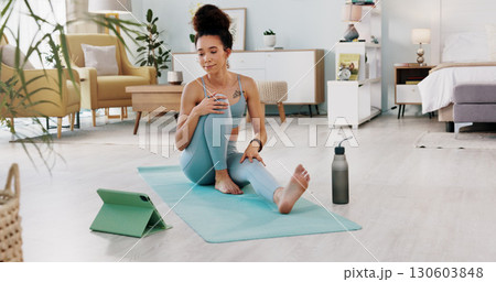 Woman, tablet and yoga for home fitness, online class and streaming in living room for meditation, wellness or health. Young person on floor for pilates, exercise and workout on digital or video call Woman, tablet and yoga for home fitness, online class and streaming in living room for meditation, wellness or health. Young person on floor for pilates, exercise and workout on digital or video call 130603848
