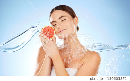 Beauty, skincare and woman with grapefruit and water for natural skin dermatology. Clean splash and face of aesthetic model in studio for sustainable fruit self care for health and spa wellness Beauty, skincare and woman with grapefruit and water for natural skin dermatology. Clean splash and face of aesthetic model in studio for sustainable fruit self care for health and spa wellness 130603872