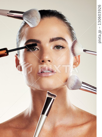 Makeup brush, beauty and face of a woman in studio for cosmetic product advertising. Aesthetic model person with skin tools for facial skincare and dermatology with glow using mascara and foundation Makeup brush, beauty and face of a woman in studio for cosmetic product advertising. Aesthetic model person with skin tools for facial skincare and dermatology with glow using mascara and foundation 130603926