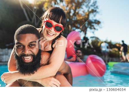 Love, pool party and couple piggyback, having fun and bonding. Swimming, romance diversity and portrait of happy man carrying woman in water and laughing at funny joke at summer event or celebration. 130604034