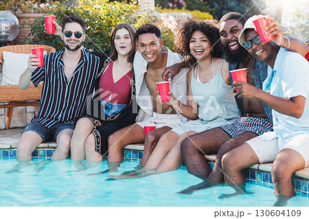 Pool party, beer and friends laughing, having fun and partying. Summer celebration, event and group portrait of people, men and women with alcohol, dip feet in water and laugh at funny joke or meme. 130604109