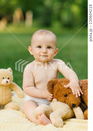 Baby Holding Teddy Bear Outdoors Baby Holding Teddy Bear Outdoors 130604218