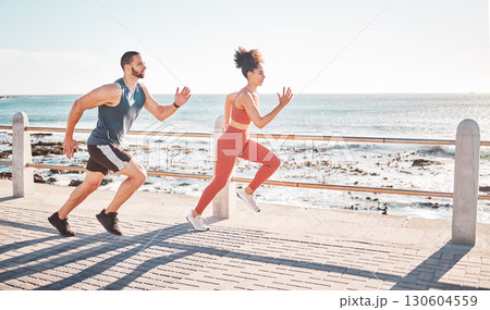 Runner, fitness and sea with a sports couple outdoor during summer for cardio or endurance exercise. Health, training and ocean with a man and woman running on a promenade for a workout together 130604559