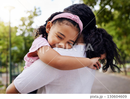 Hug, park and mother and daughter, love and sweet while bonding outdoor together. Black woman, embrace and fun in a forest, precious and happy, content and relax in a beautiful moment of motherhood 130604609