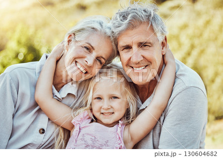 Grandparents, girl and smile portrait in a family outdoor park happy about a picnic. Children, happiness and kids with elderly grandparent in garden or backyard smiling and bonding together in nature 130604682