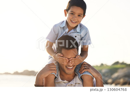 Beach, family and child of shoulder of father with hands cover eyes for bonding game, quality time and playing. Travel, family love and happy boy with dad by ocean for adventure, holiday and vacation Beach, family and child of shoulder of father with hands cover eyes for bonding game, quality time and playing. Travel, family love and happy boy with dad by ocean for adventure, holiday and vacation 130604768
