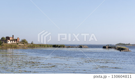 Coastal panoramic view with ruins of historical buildings under clear blue sky 130604811