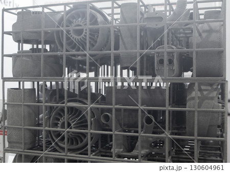 Object printed on 3D printer from molten plastic powder close-up. Model printed on 3D printer from melted polyamide powder. New modern additive 3D printing technology. Multi Jet Fusion MJF technology Object printed on 3D printer from molten plastic powder close-up. Model printed on 3D printer from melted polyamide powder. New modern additive 3D printing technology. Multi Jet Fusion MJF technology 130604961