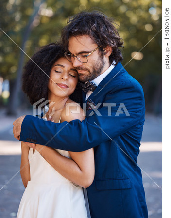 Interracial wedding, black woman and man with hug with smile, happiness or future together. African bride, husband and diversity at outdoor marriage for love, embrace or eye contact in sunshine Interracial wedding, black woman and man with hug with smile, happiness or future together. African bride, husband and diversity at outdoor marriage for love, embrace or eye contact in sunshine 130605106