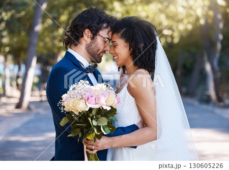 Married couple, flower bokeh and smile for commitment, marriage or love together in the park. Happy groom and bride smiling in happiness for honeymoon, romance and embracing relationship in nature 130605226