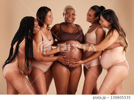 Women, hands or touching pregnant stomach of black woman on studio background in support, bonding love or life insurance. Smile, happy or friends in pregnancy underwear and feeling baby kick in belly 130605535