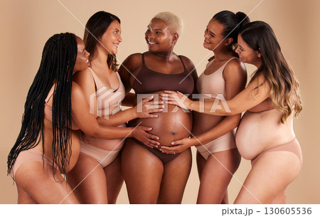 Happy women, hands or touching pregnant stomach of black woman on studio background in support, love or life insurance. Smile, bonding or friends in pregnancy underwear and feeling baby kick in belly Happy women, hands or touching pregnant stomach of black woman on studio background in support, love or life insurance. Smile, bonding or friends in pregnancy underwear and feeling baby kick in belly 130605536