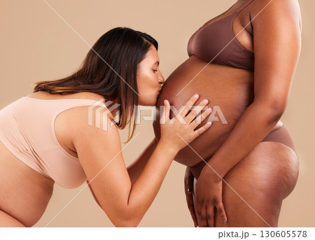 Women, love or kissing pregnant tummy on studio background in mom trust, support or baby healthcare. Friends, pregnancy or bonding mothers in underwear affection for body diversity or growth wellness 130605578