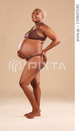 Black woman, laughing or holding pregnant stomach on studio background in body empowerment, love or baby support. Smile, happy and pregnancy model in body underwear or ready for motherhood on mock up 130605580