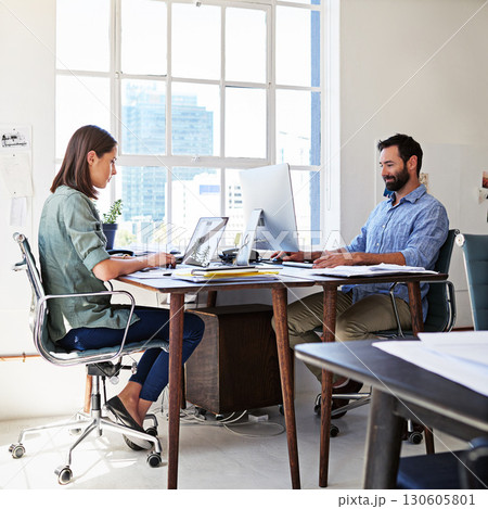 Coworkers, concentration and man and woman in coworking space at creative agency working together on startup project. Teamwork, computer and website, employees or business people at design office. 130605801