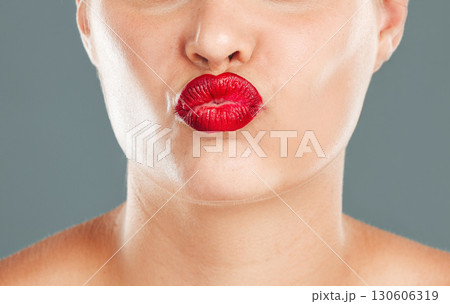 Kiss face zoom, lipstick and woman lips with makeup, red cosmetics and pout isolated on studio background. Healthy skin, beauty and skincare with cosmetic care, wellness and facial glow with shine Kiss face zoom, lipstick and woman lips with makeup, red cosmetics and pout isolated on studio background. Healthy skin, beauty and skincare with cosmetic care, wellness and facial glow with shine 130606319