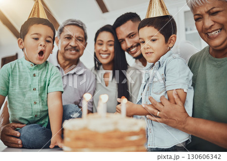 Kid, birthday candles and child with cake at a house at a party with food and celebration. Children, celebrate event and family together in a kitchen with a smile and happiness with parent love Kid, birthday candles and child with cake at a house at a party with food and celebration. Children, celebrate event and family together in a kitchen with a smile and happiness with parent love 130606342