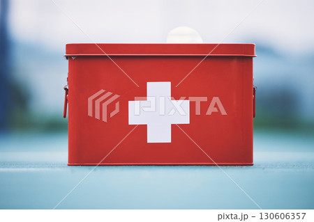 First aid, box and medical equipment for health emergency, response and treatment kit isolated in a blurred background. Red, cross and safety or medicine on a table for fast healthcare or cure First aid, box and medical equipment for health emergency, response and treatment kit isolated in a blurred background. Red, cross and safety or medicine on a table for fast healthcare or cure 130606357