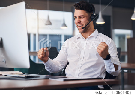 Man, call center and celebration for winning, sale or promotion in customer support or service at office desk. Happy male consultant celebrating in success for telemarketing, deal or discount on PC 130606403