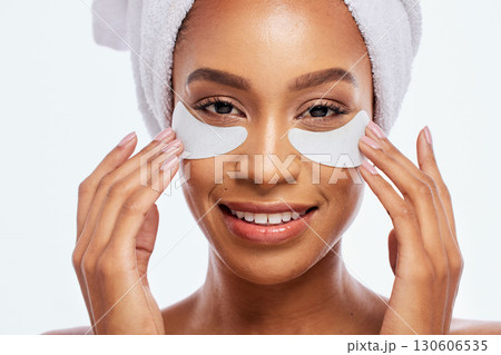 Black woman, beauty and eye patch portrait in studio for dermatology, cosmetics and natural skincare. Face of aesthetic model with collagen spa facial and healthy glow isolated on a white background Black woman, beauty and eye patch portrait in studio for dermatology, cosmetics and natural skincare. Face of aesthetic model with collagen spa facial and healthy glow isolated on a white background 130606535