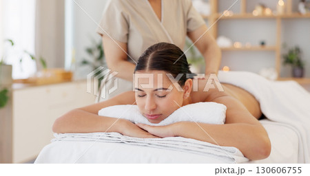 Relax, massage and woman in spa for luxury treatment, skincare and wellness with masseuse. Resort salon, beauty and person massaging back for zen health, physical therapy and holistic stress relief 130606755