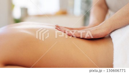 Hands, back massage and a person on a spa table for wellness, luxury treatment or stress relief closeup. Relax, health and skin with a beauty therapist massaging a customer at a resort or salon 130606771