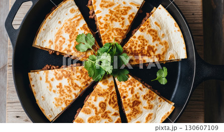 Beef Quesadilla Slices in Cast Iron Pan with Cilantro Beef Quesadilla Slices in Cast Iron Pan with Cilantro 130607109