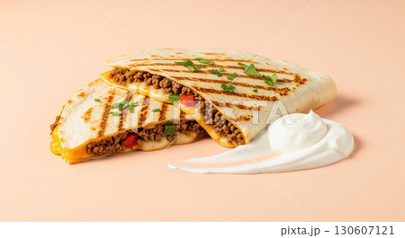 Grilled Beef Quesadilla with Sour Cream on Peach Background Grilled Beef Quesadilla with Sour Cream on Peach Background 130607121