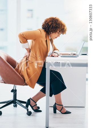 Black woman in business with back pain, burnout and stress, stiff muscle from spine injury and overworked. Female worker at desk, corporate and medical emergency with health problem and strain Black woman in business with back pain, burnout and stress, stiff muscle from spine injury and overworked. Female worker at desk, corporate and medical emergency with health problem and strain 130607333