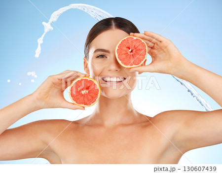 Beauty, water and portrait of happy woman with grapefruit for fruit detox, health wellness or natural facial skincare. Spa salon, cleaning and nutritionist model with food product for vitamin c glow 130607439