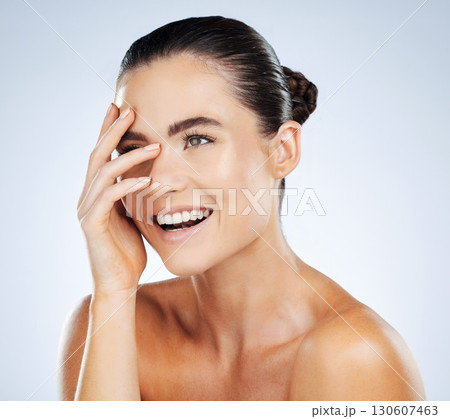 Beauty, skincare and hand on face of a woman in studio with a smile for natural cosmetic product. Aesthetic model person happy about makeup, facial and dermatology for skin glow and spa wellness Beauty, skincare and hand on face of a woman in studio with a smile for natural cosmetic product. Aesthetic model person happy about makeup, facial and dermatology for skin glow and spa wellness 130607463