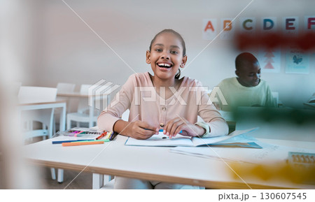Education, learning and portrait of child with smile in classroom for reading, writing and math in Montessori school. Books, students and happy girl at desk with fun notebook studying for future exam Education, learning and portrait of child with smile in classroom for reading, writing and math in Montessori school. Books, students and happy girl at desk with fun notebook studying for future exam 130607545