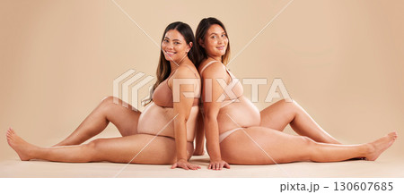 Friends, pregnancy and studio portrait for underwear, smile and women sitting together for support on floor. Happy future mom, pregnant or solidarity for health, love or healthy stomach by background 130607685