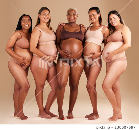 Pregnancy, diversity and portrait of friends in studio for community, motherhood and prenatal wellness. Maternity, love and pregnant women showing their baby bump stomach together by beige background 130607697