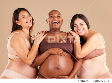 Portrait, beauty and body with pregnant friends in studio on a beige background for diversity or motherhood. Family, love and pregnancy with a woman friend group showing their baby bump stomach Portrait, beauty and body with pregnant friends in studio on a beige background for diversity or motherhood. Family, love and pregnancy with a woman friend group showing their baby bump stomach 130607704