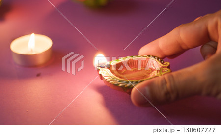 Closeup of hand holding lit candle 130607727