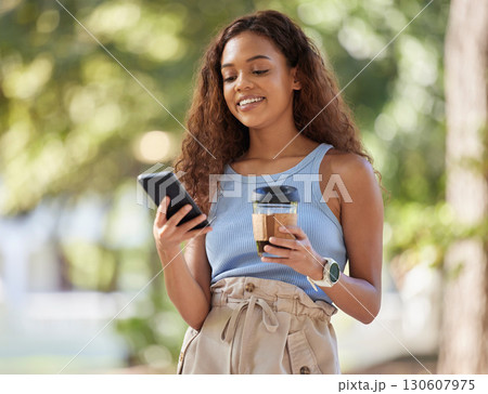 Coffee, phone and black woman typing at park, outdoors or outside. Cellphone, tea or happy female with caffeine while texting, social media or networking, scrolling or messaging on mobile smartphone. Coffee, phone and black woman typing at park, outdoors or outside. Cellphone, tea or happy female with caffeine while texting, social media or networking, scrolling or messaging on mobile smartphone. 130607975