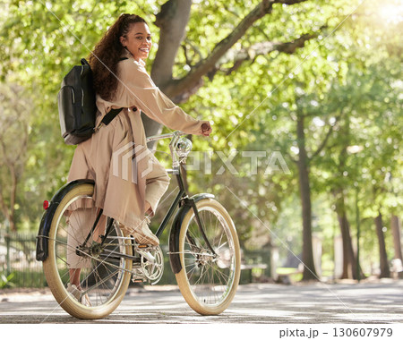 Bicycle, bike and woman travel in a park outdoors in nature happy and excited on fun ride or commuting. Exercise, wellness and lifestyle female student cycling and relaxing on eco friendly traveling Bicycle, bike and woman travel in a park outdoors in nature happy and excited on fun ride or commuting. Exercise, wellness and lifestyle female student cycling and relaxing on eco friendly traveling 130607979