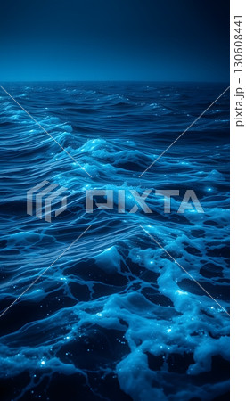 Serene Ocean Waves Gently Reflecting Moonlight Under the Dark Blue Sky 130608441