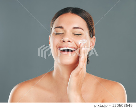 Skincare, beauty cream and woman with happiness from sunscreen and self care in studio. Wellness, spa and smile of a model laugh with collagen lotion with studio background and dermatology treatment Skincare, beauty cream and woman with happiness from sunscreen and self care in studio. Wellness, spa and smile of a model laugh with collagen lotion with studio background and dermatology treatment 130608649