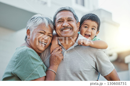 Grandparents, hug and child with smile for happy holiday or weekend break with elderly people at the house. Portrait of grandma and grandpa holding little boy on back for fun playful summer together Grandparents, hug and child with smile for happy holiday or weekend break with elderly people at the house. Portrait of grandma and grandpa holding little boy on back for fun playful summer together 130608731