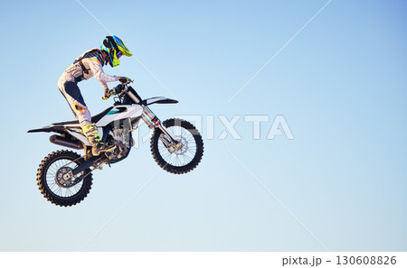 Motorcycle, jump and person on blue sky mockup for training, competition or challenge with safety gear. Professional cycling, motorbike and adventure with speed, sports and danger in mock up space Motorcycle, jump and person on blue sky mockup for training, competition or challenge with safety gear. Professional cycling, motorbike and adventure with speed, sports and danger in mock up space 130608826