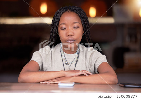 Depression, sad and woman with phone in coffee shop during breakup or fight on her cellphone. Depressed, moody and unhappy African female with mental health problem with mobile after argument in cafe Depression, sad and woman with phone in coffee shop during breakup or fight on her cellphone. Depressed, moody and unhappy African female with mental health problem with mobile after argument in cafe 130608877