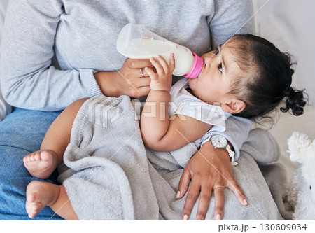 Mom feeding baby, milk formula and nutrition with drinking, family and healthy, growth and childhood development. Woman feed infant child at home, meal and hands with health and wellness 130609034