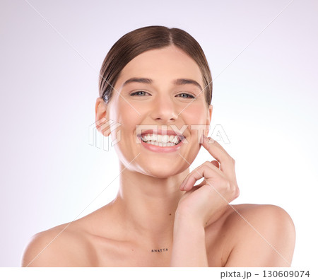 Beauty, woman and portrait in studio for skincare, dermatology and wellness cosmetics on background. Happy female model, smile and aesthetic glow of shine, laser transformation and facial spa results 130609074