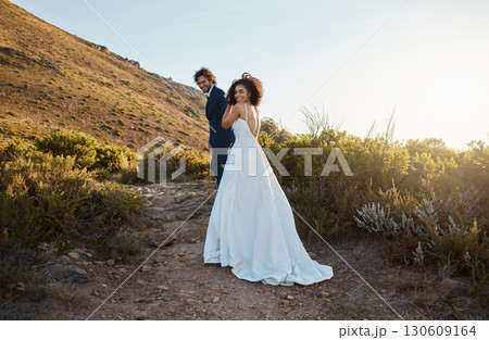 Love, wedding or a couple of friends in countryside after a romantic celebration in an interracial marriage. Life partner, black woman and happy man enjoy a peaceful memory walking as bride and groom Love, wedding or a couple of friends in countryside after a romantic celebration in an interracial marriage. Life partner, black woman and happy man enjoy a peaceful memory walking as bride and groom 130609164