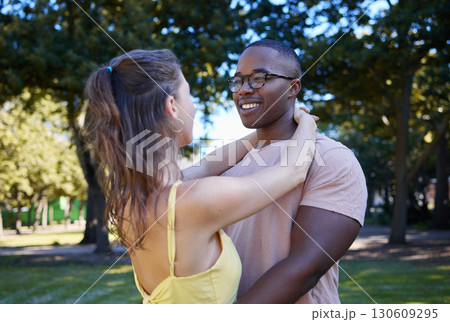 Summer, love and diversity with a couple bonding outdoor together in a park or natural garden. Nature, interracial and romance with a man and woman hugging while on a date outside in the countryside Summer, love and diversity with a couple bonding outdoor together in a park or natural garden. Nature, interracial and romance with a man and woman hugging while on a date outside in the countryside 130609295