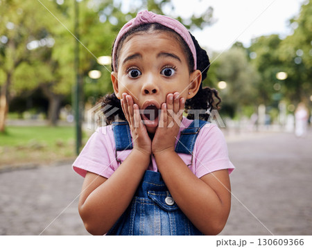 Wow, surprise and girl child at park outdoors looking shocked. Face portrait, omg and shock of kid from South Africa with surprised facial expression after good news while on holiday or vacation. Wow, surprise and girl child at park outdoors looking shocked. Face portrait, omg and shock of kid from South Africa with surprised facial expression after good news while on holiday or vacation. 130609366