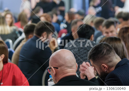 Blurred background of a business meeting with diverse attendees 130610040